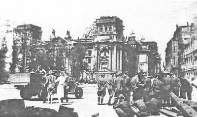 Russian soldiers in front of the destroyed 